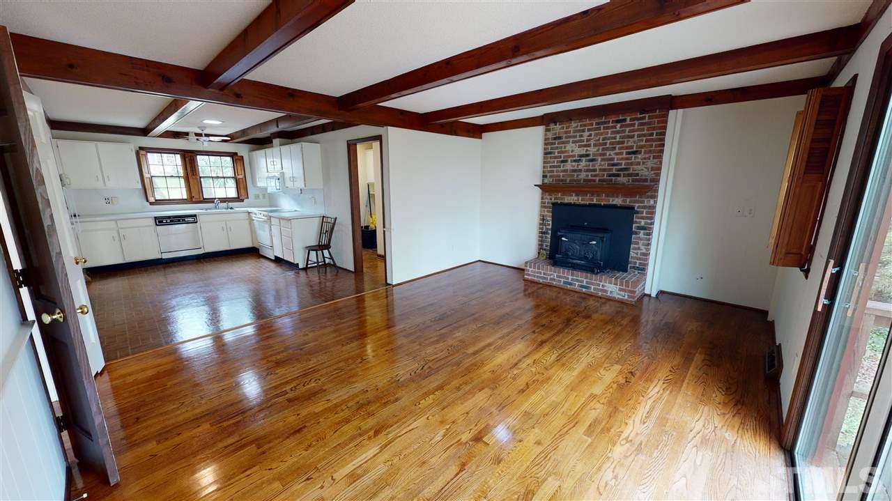 1114 Manchester Drive Raleigh, NC 27609 - Photo 19 of 30 a view of an empty room with wooden floor and a window