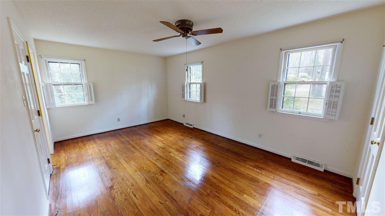 1114 Manchester Drive Raleigh, NC 27609 - Photo 20 of 30 a view of empty room with wooden floor and fan