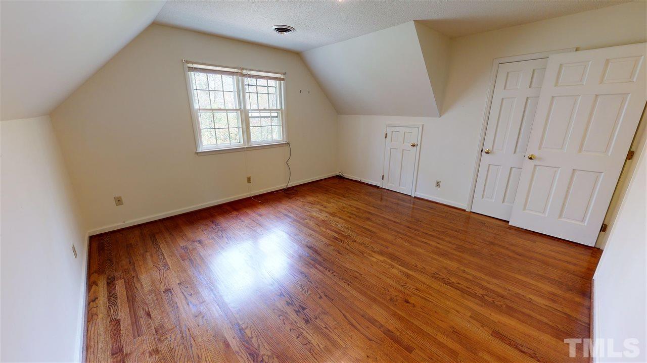1114 Manchester Drive Raleigh, NC 27609 - Photo 28 of 30 an empty room with wooden floor and windows