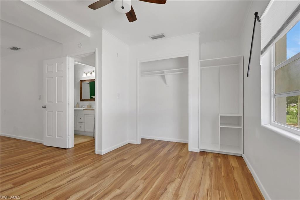 11360 Hunting Road Bonita Springs, FL 34135 - Photo 21 of 27 Bright room featuring wood-finish flooring, a ceiling fan, and white walls