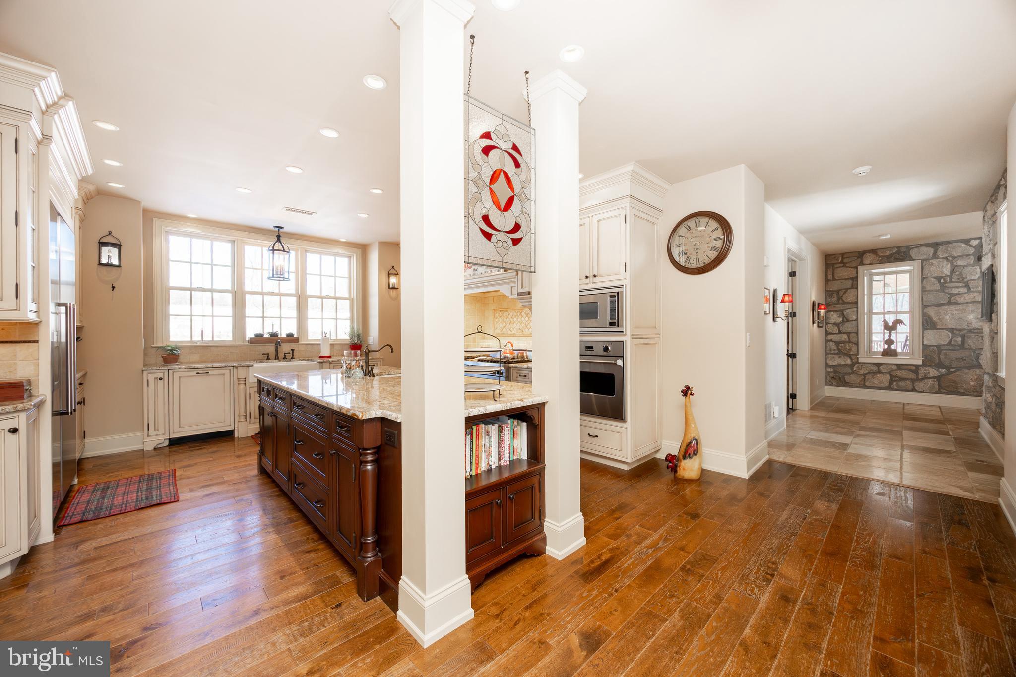 2230 Creek Road Glenmoore, PA 19343 - Photo 19 of 86 a view of a kitchen center island wooden floor and stainless steel appliances
