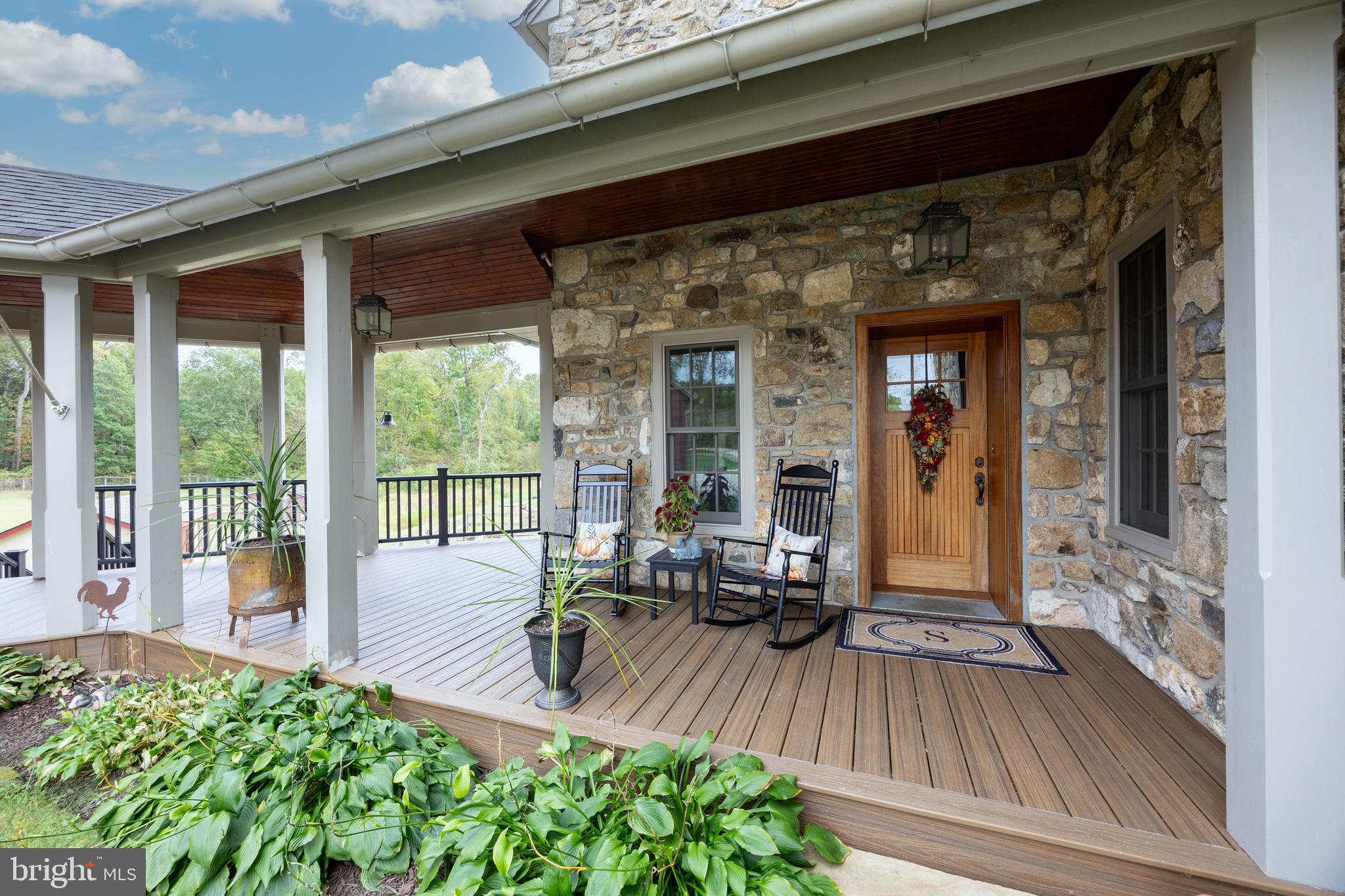 2230 Creek Road Glenmoore, PA 19343 - Photo 2 of 86 a view of a patio with table and chairs potted plants with wooden floor and fence