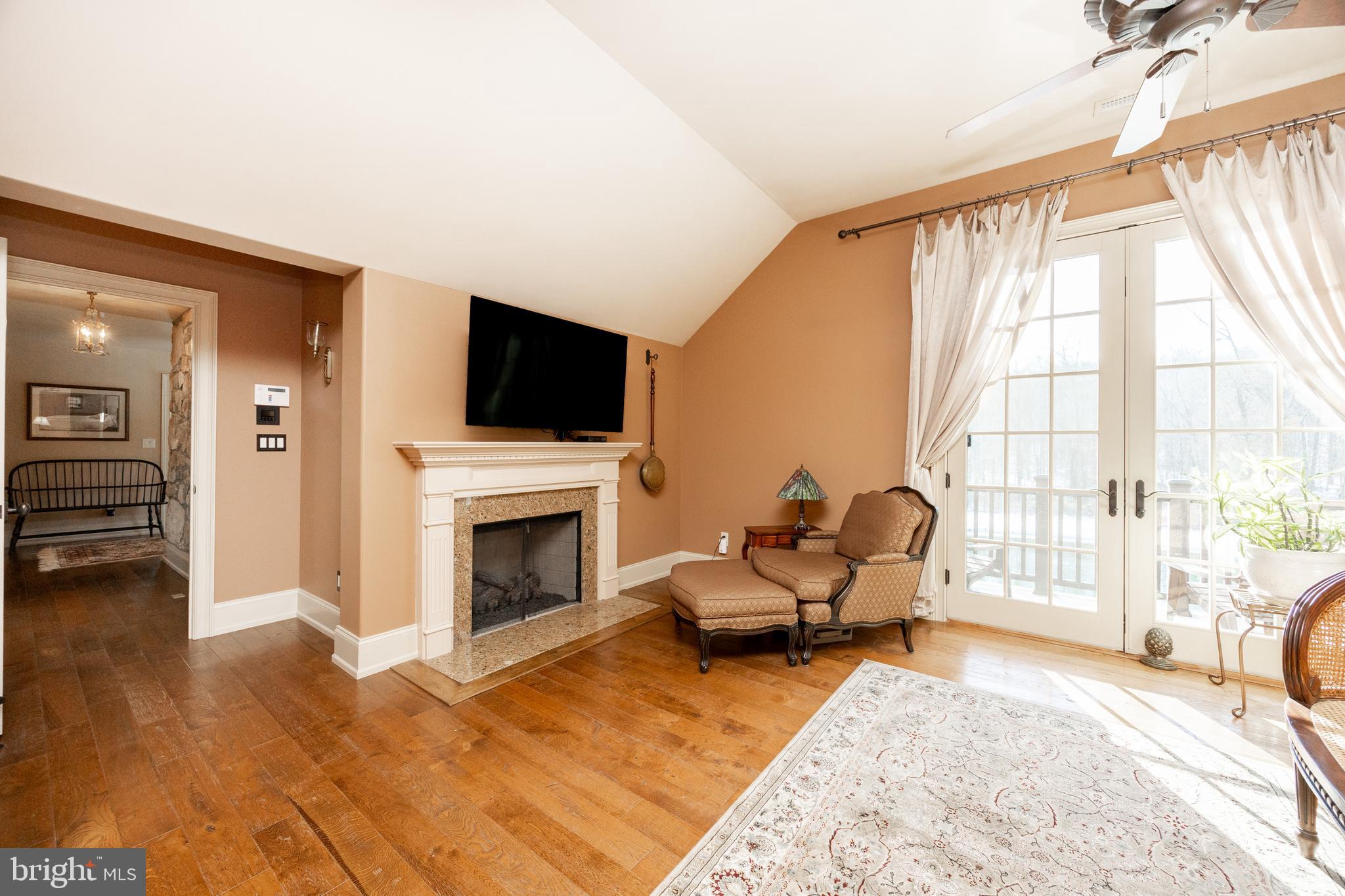 2230 Creek Road Glenmoore, PA 19343 - Photo 29 of 86 a living room with furniture a fireplace and a flat screen tv