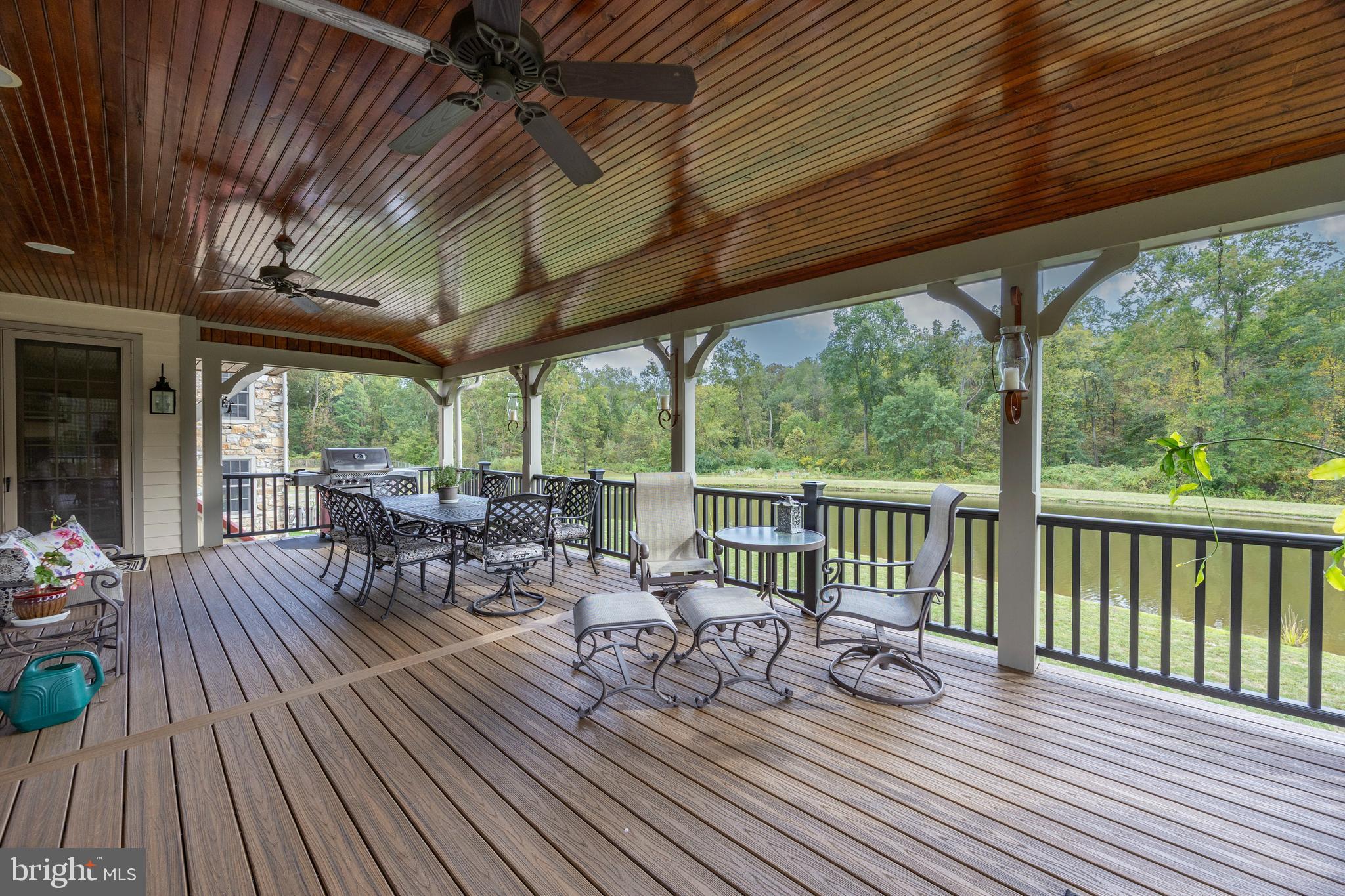 2230 Creek Road Glenmoore, PA 19343 - Photo 72 of 86 a view of a patio with table and chairs and wooden floor