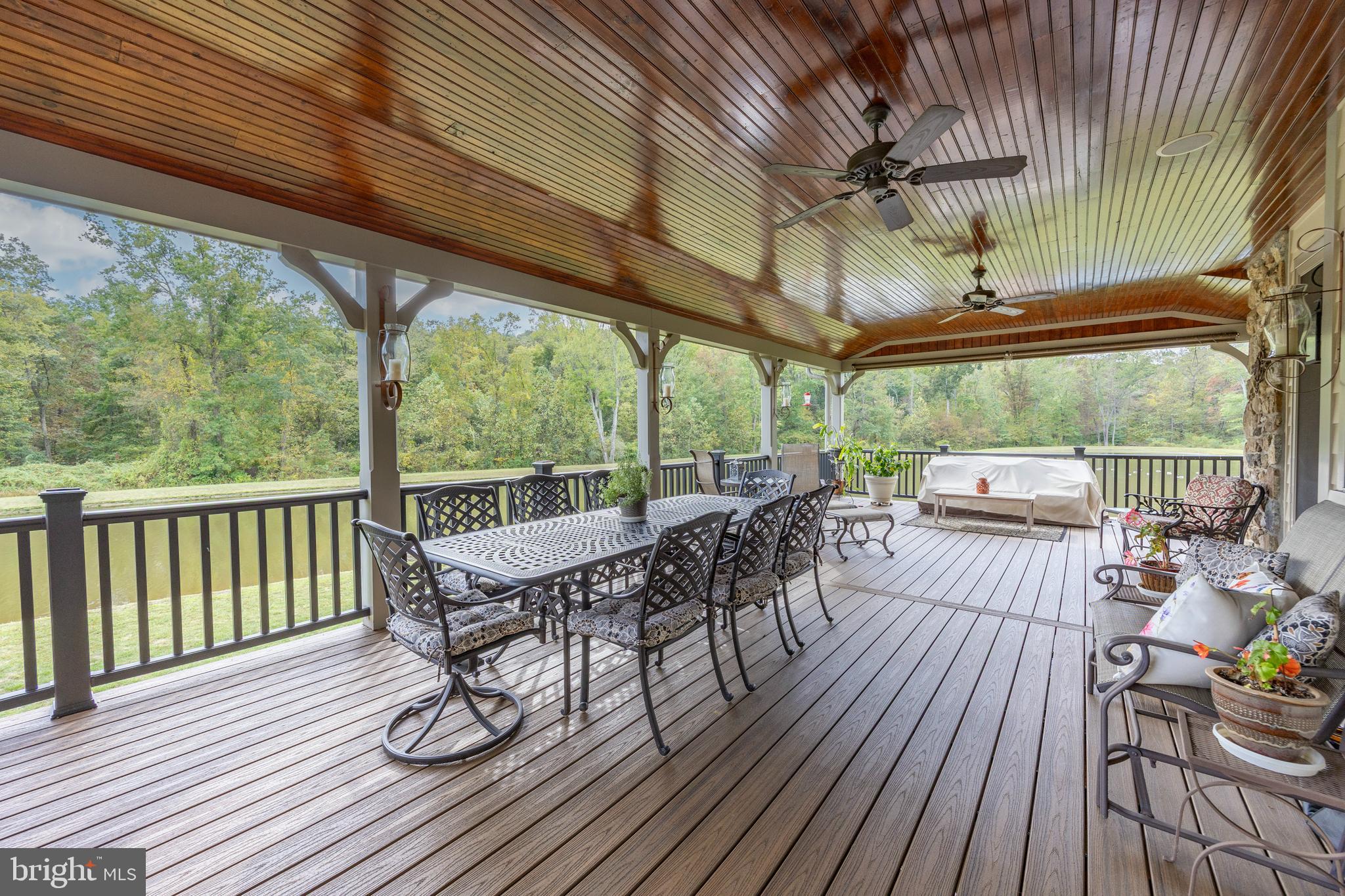 2230 Creek Road Glenmoore, PA 19343 - Photo 73 of 86 a view of a patio with table and chairs and wooden floor