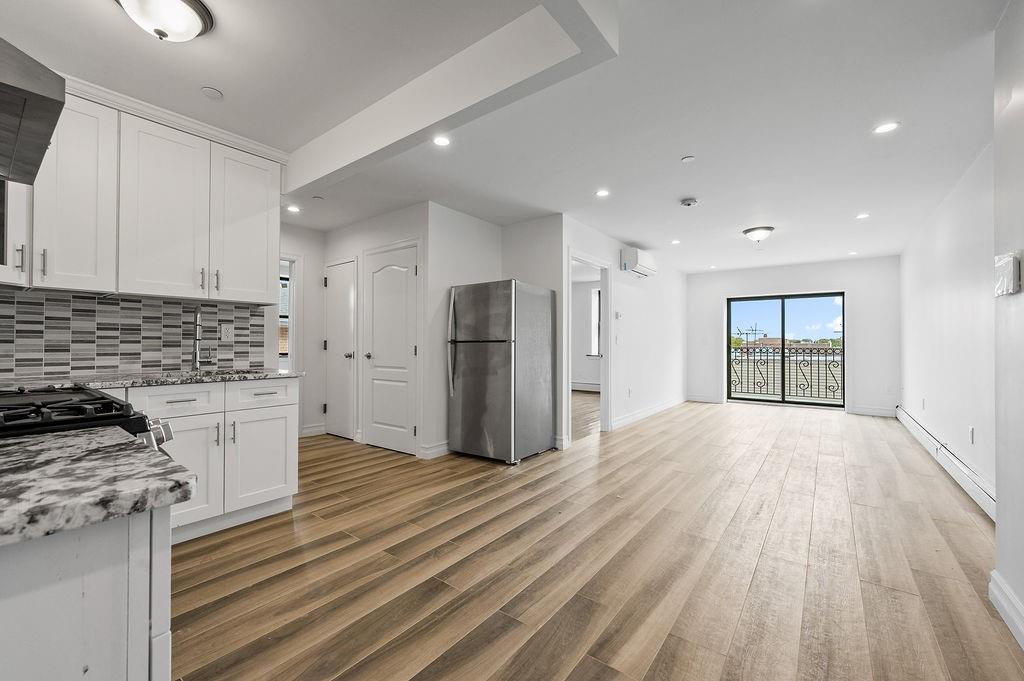 1307 84th Street, Unit 3B Brooklyn, NY 11228 - Photo 4 of 17 a view of a kitchen with a stove cabinets and wooden floor