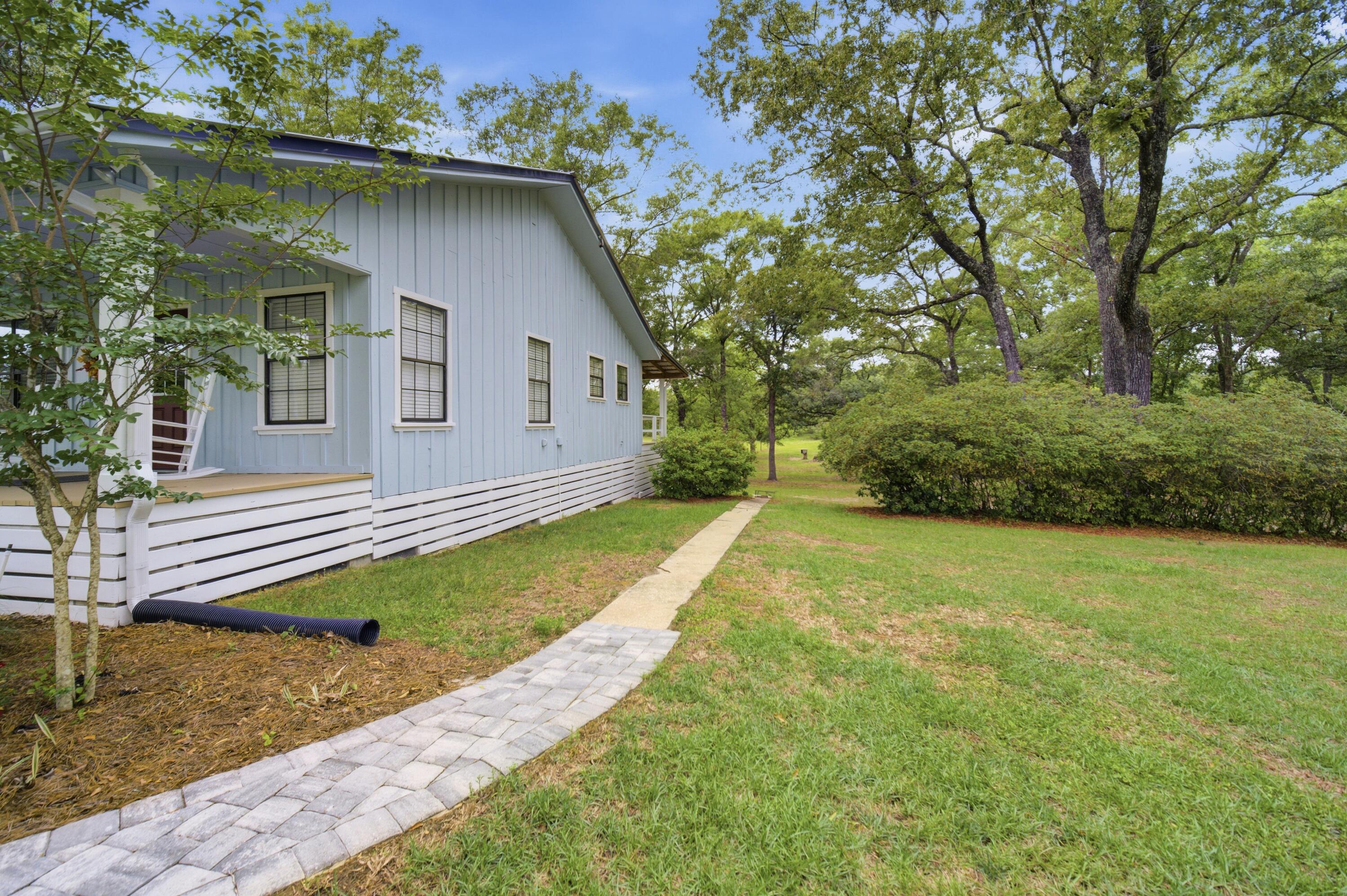 261 Wilkerson Road DeFuniak Springs, FL 32433 - Photo 45 of 76 a front view of a house with garden