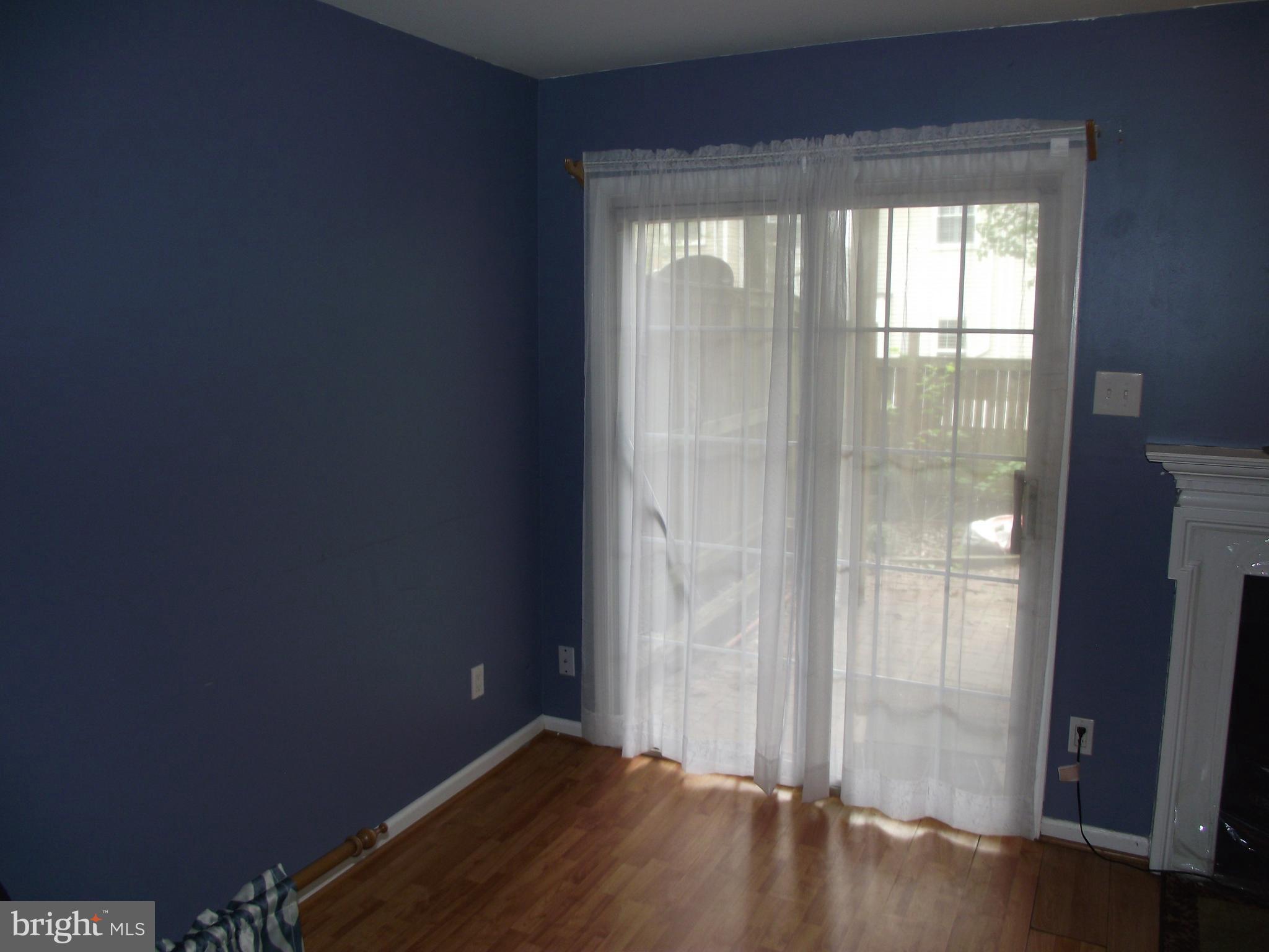 8502 Kernon Court, Unit BASEMENT APARTMENT Lorton, VA 22079 - Photo 7 of 10 an empty room with wooden floor and windows