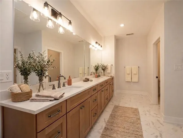 a kitchen with white cabinets and a sink