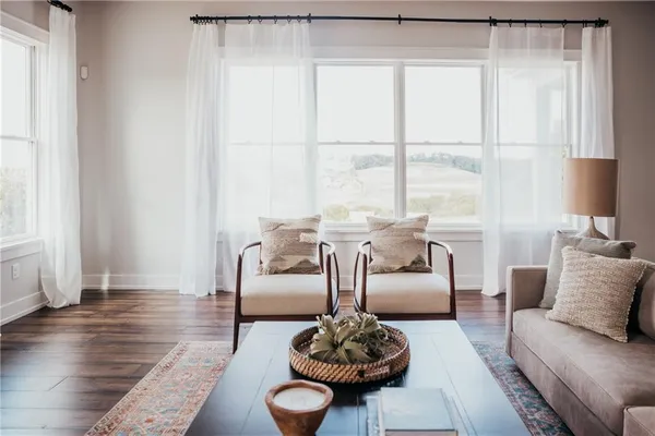 a kitchen with a dining table chairs and white cabinets