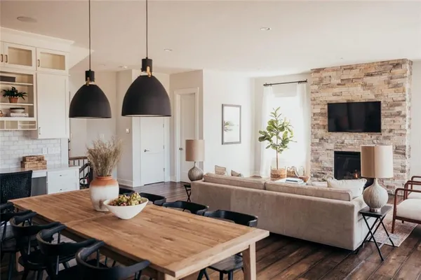 a dining room with furniture and wooden floor