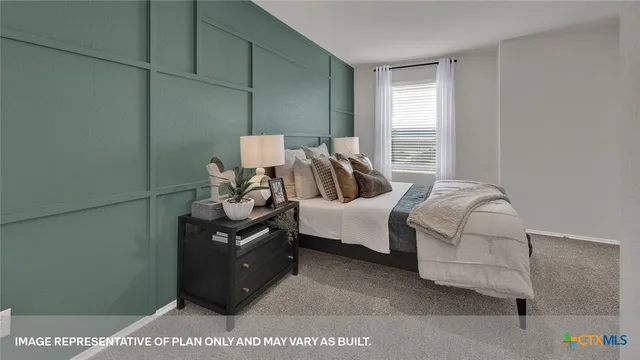 a bedroom with a bed and dresser with mirror