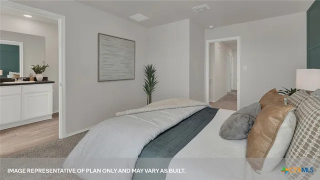 a bedroom with a bed and a cabinets