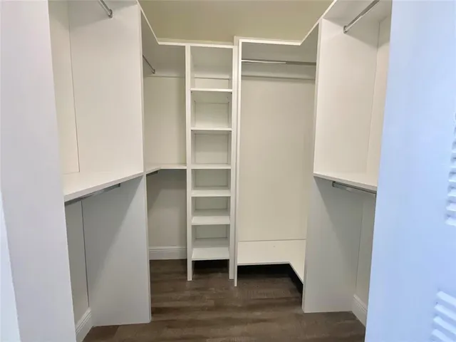 a view of walk in closet with empty racks