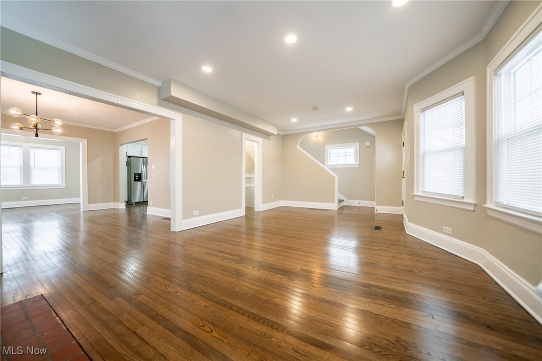 3816 Summit Park Road Cleveland Heights, OH 44121 - Photo 5 of 35 Unfurnished living room featuring crown molding, dark wood-type flooring, a chandelier, and recessed lighting