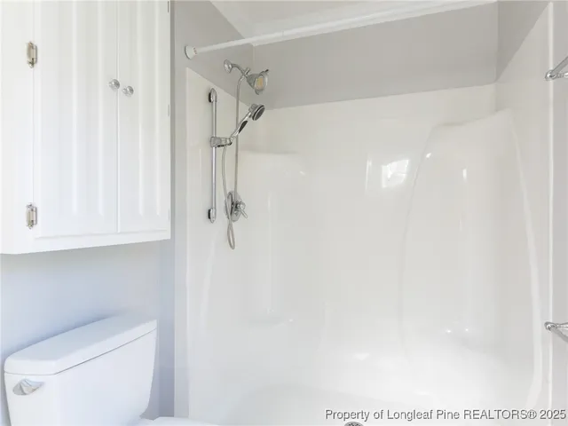 a bathroom with a shower and toilet