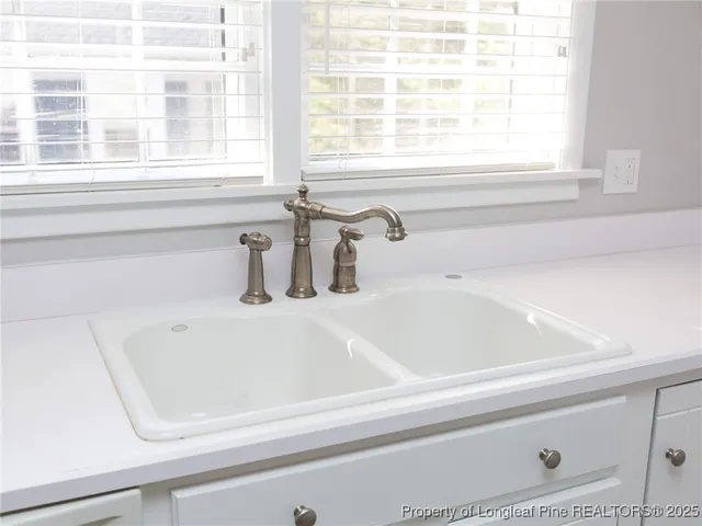 a bathroom with a bathtub and next to a window
