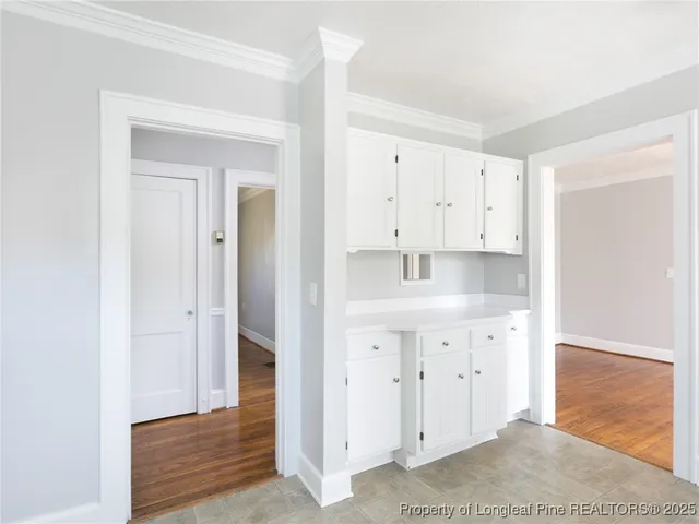 a view of kitchen with white cabinets