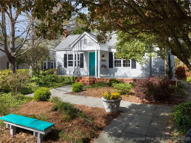 a front view of a house with a yard and fountain