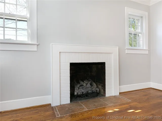 a view of a livingroom with a fireplace and wooden floor