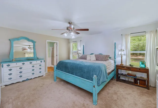 a spacious bedroom with a bed and a dresser