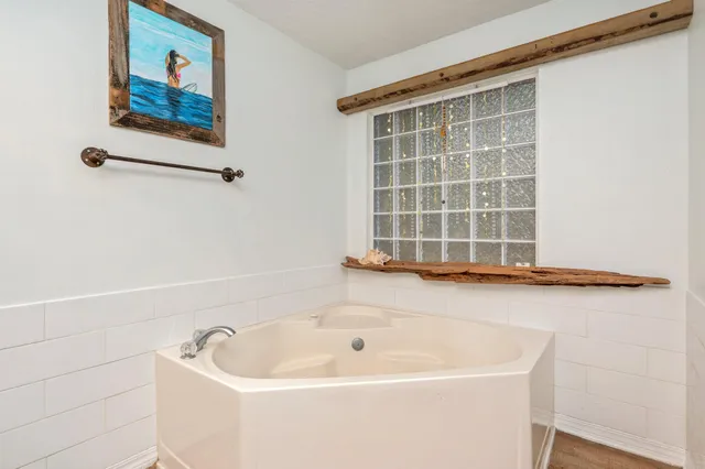 a bathroom with a bathtub and a window