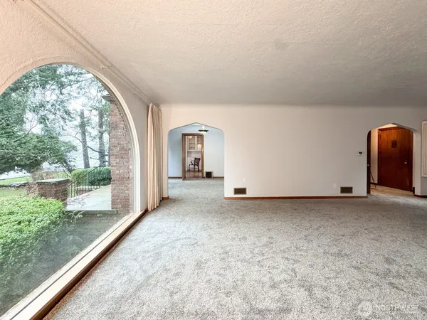 a view of a room with wooden floor and windows