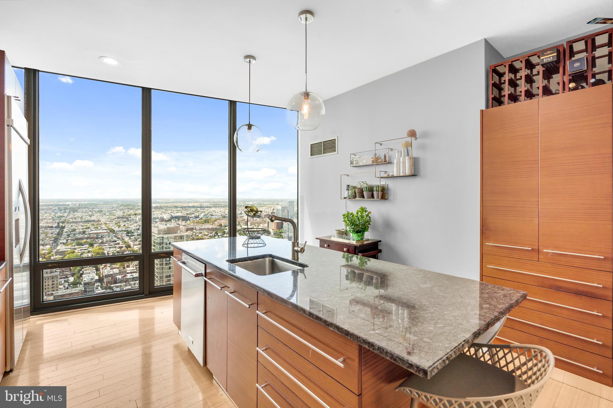 2101 Market Street, Unit PH02 Philadelphia, PA 19103 - Photo 13 of 56 a kitchen with kitchen island a large counter top space and a sink