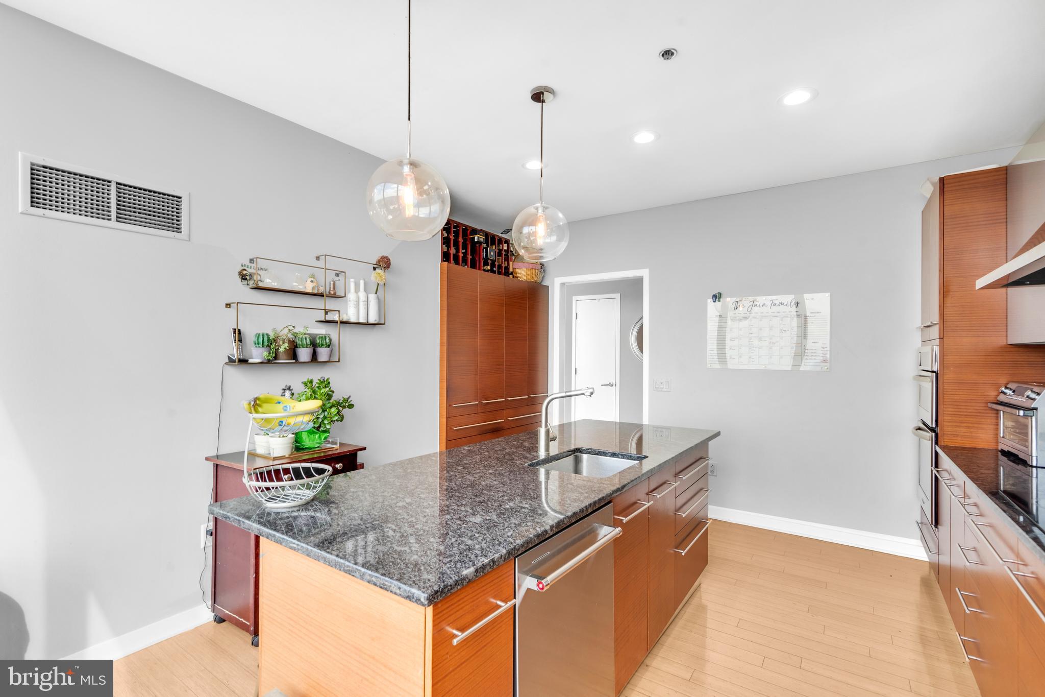 2101 Market Street, Unit PH02 Philadelphia, PA 19103 - Photo 14 of 56 a kitchen with granite countertop a sink a counter top space and cabinets