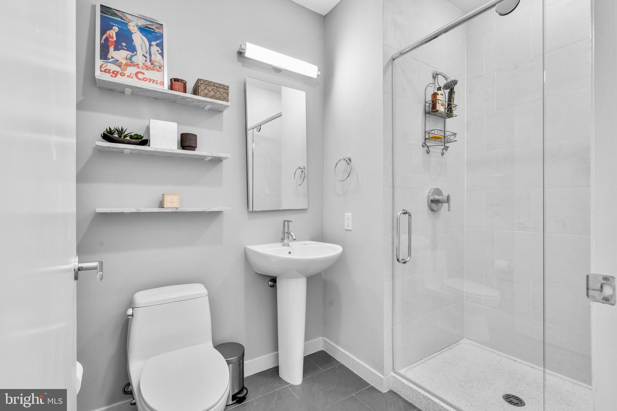 2101 Market Street, Unit PH02 Philadelphia, PA 19103 - Photo 18 of 56 a bathroom with a toilet sink and shower