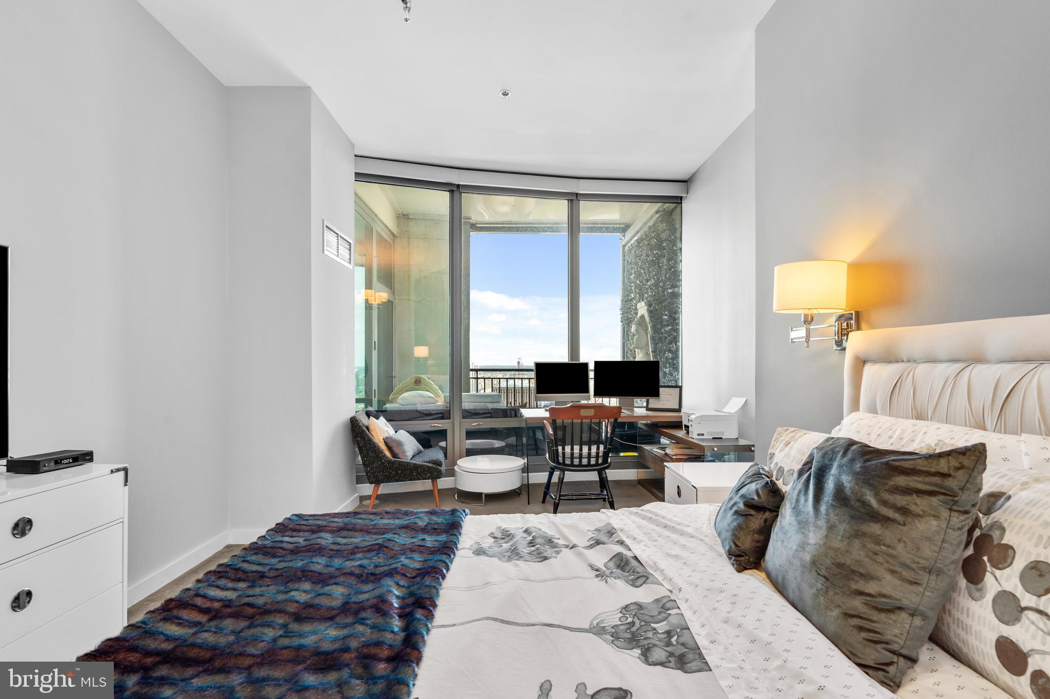 2101 Market Street, Unit PH02 Philadelphia, PA 19103 - Photo 22 of 56 a living room with furniture lamp and a large window