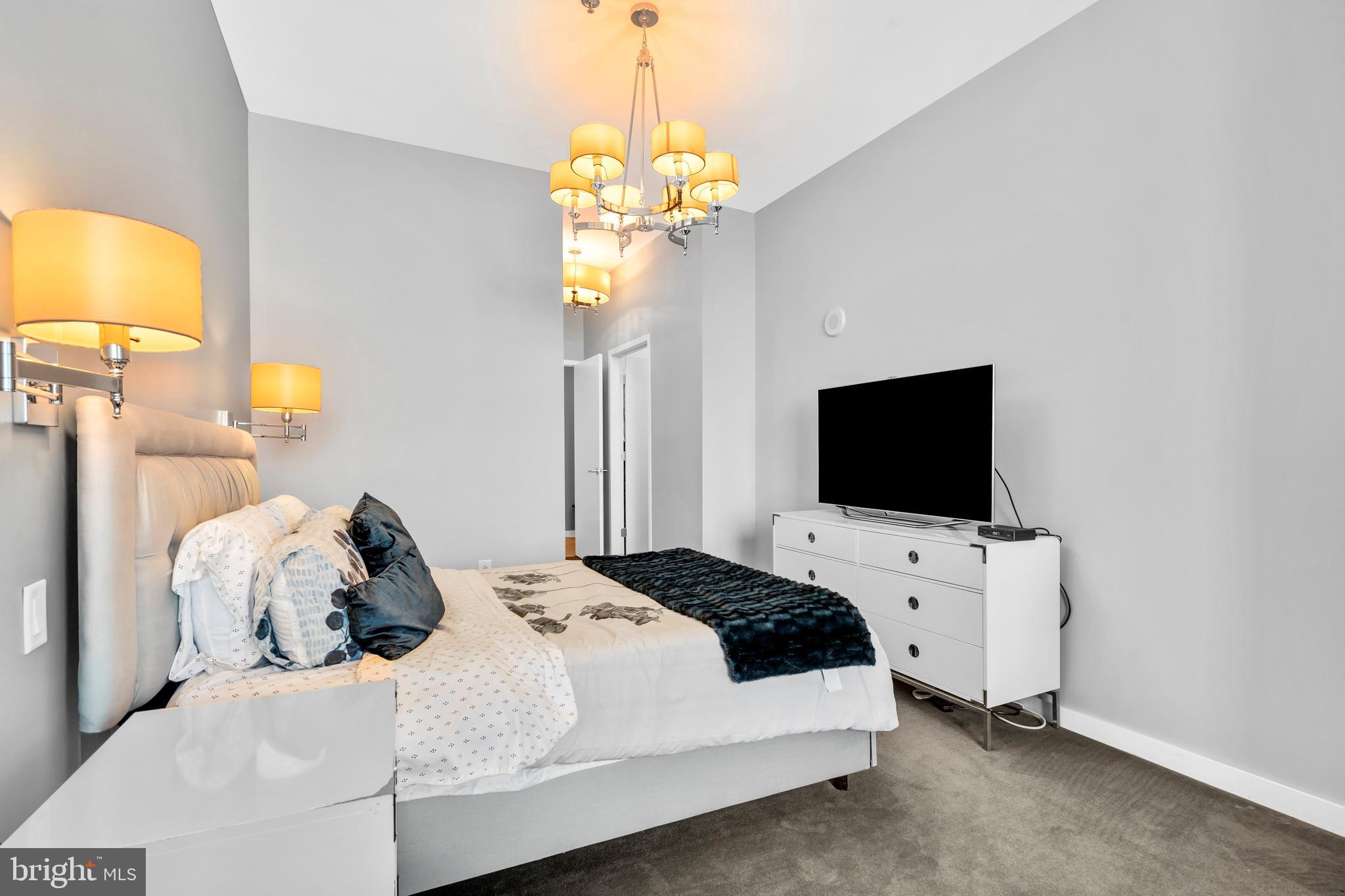 2101 Market Street, Unit PH02 Philadelphia, PA 19103 - Photo 23 of 56 a bedroom with a bed and a flat screen tv