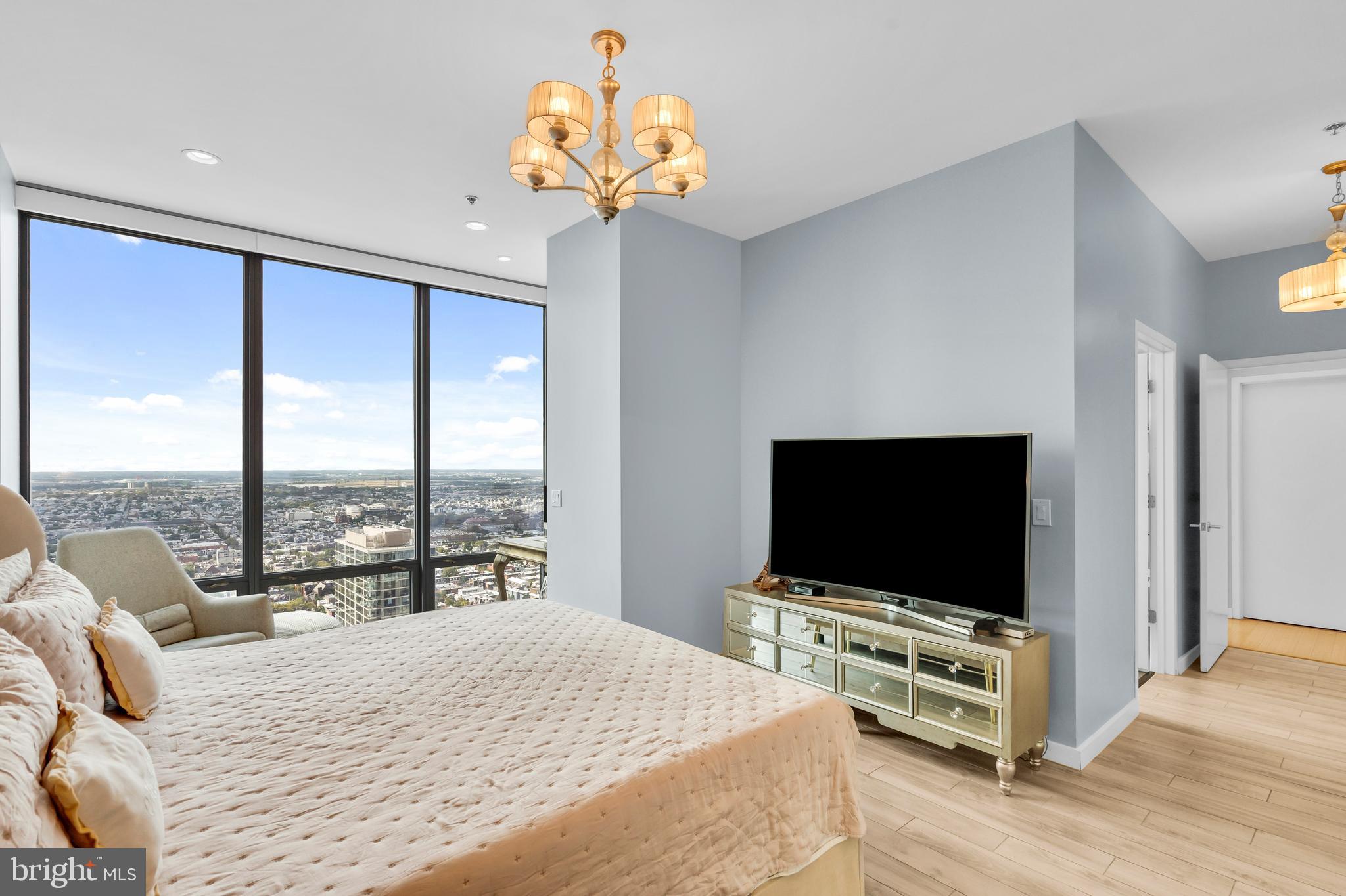 2101 Market Street, Unit PH02 Philadelphia, PA 19103 - Photo 34 of 56 a bedroom with furniture and a flat screen tv