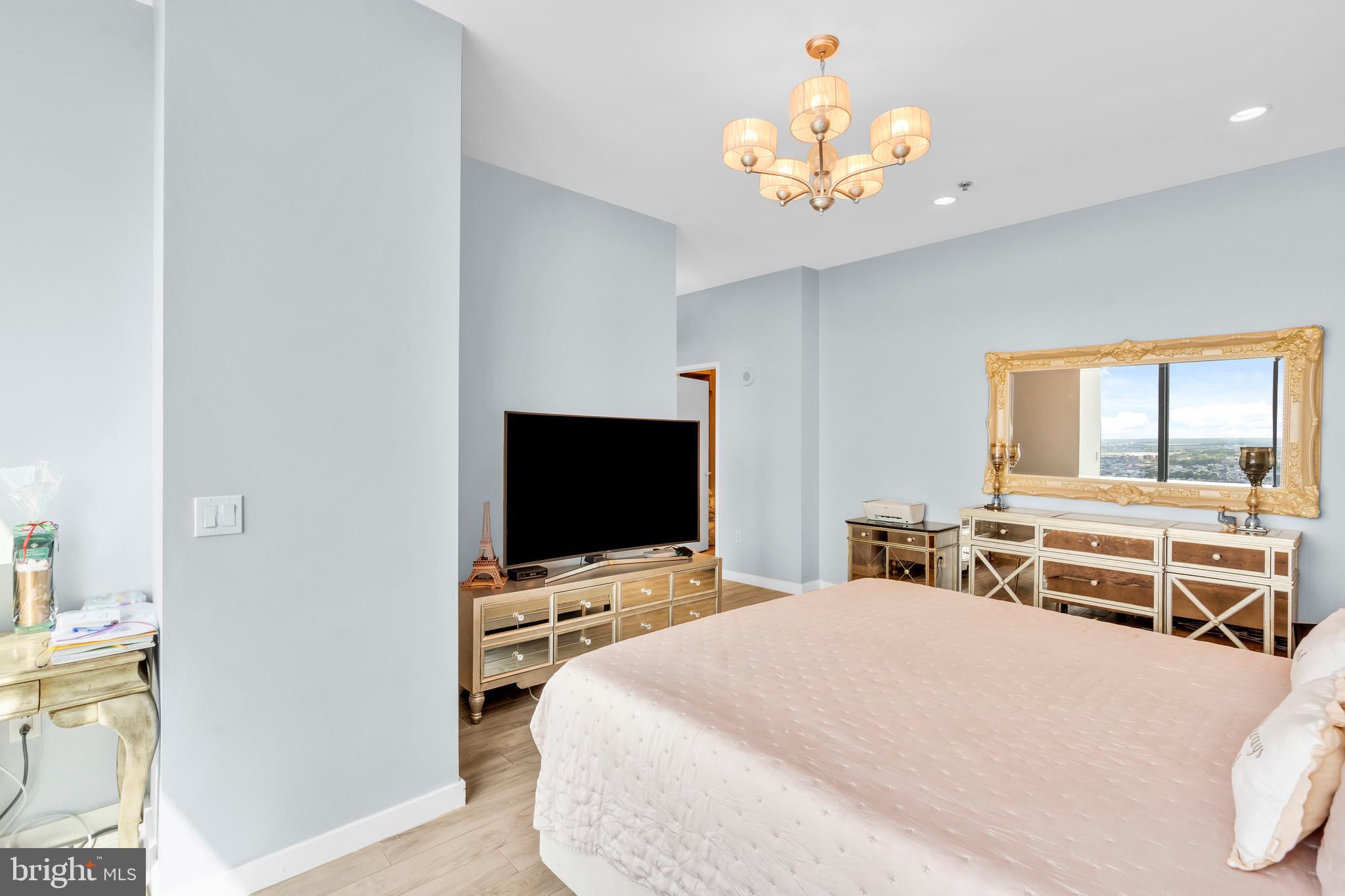 2101 Market Street, Unit PH02 Philadelphia, PA 19103 - Photo 36 of 56 a bedroom with a bed and a flat screen tv