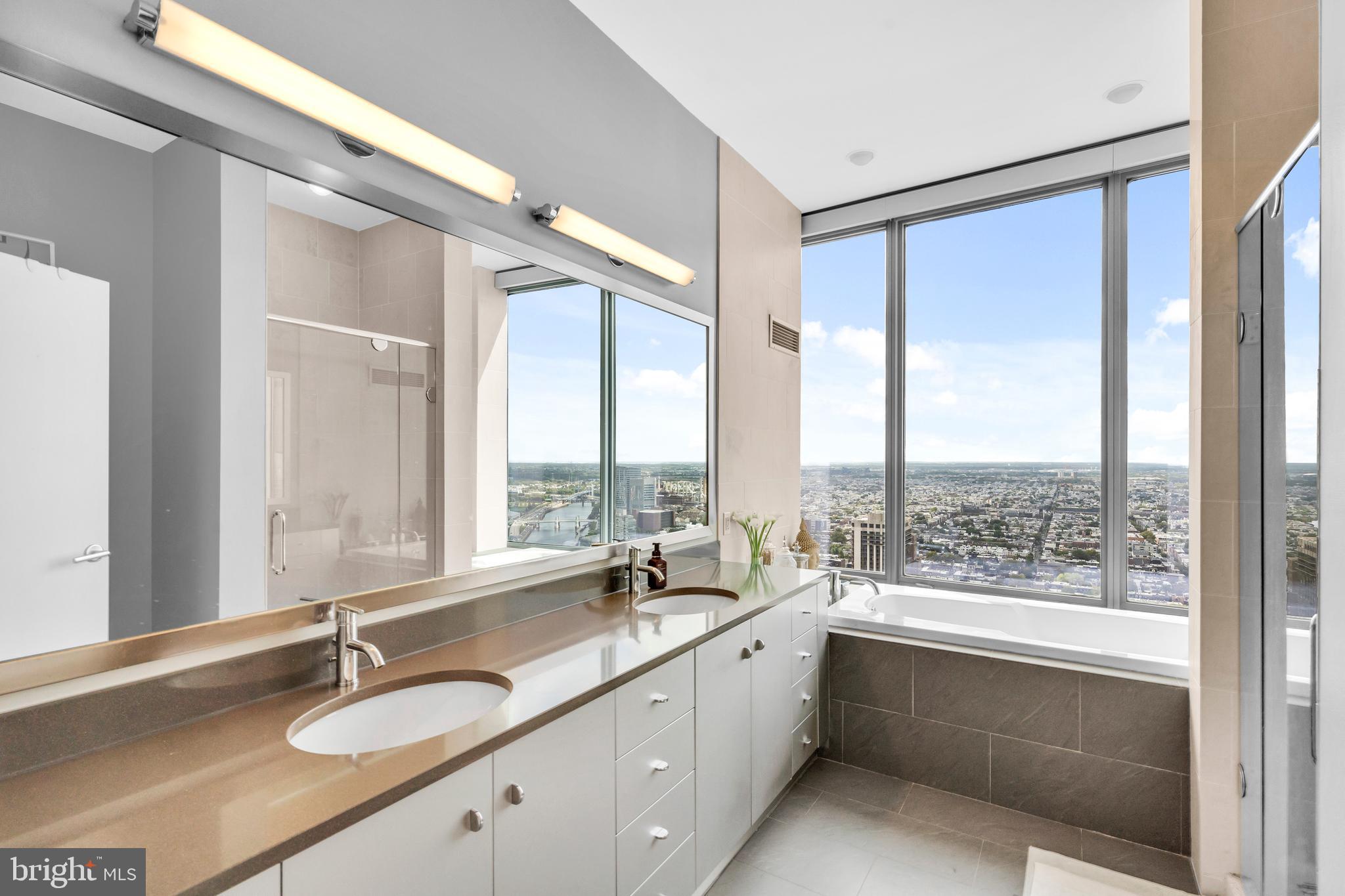 2101 Market Street, Unit PH02 Philadelphia, PA 19103 - Photo 38 of 56 a bathroom with a granite countertop sink and a large window