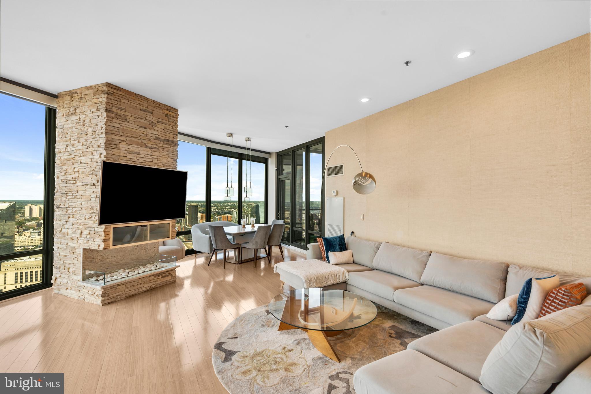 2101 Market Street, Unit PH02 Philadelphia, PA 19103 - Photo 4 of 56 a living room with furniture and a flat screen tv
