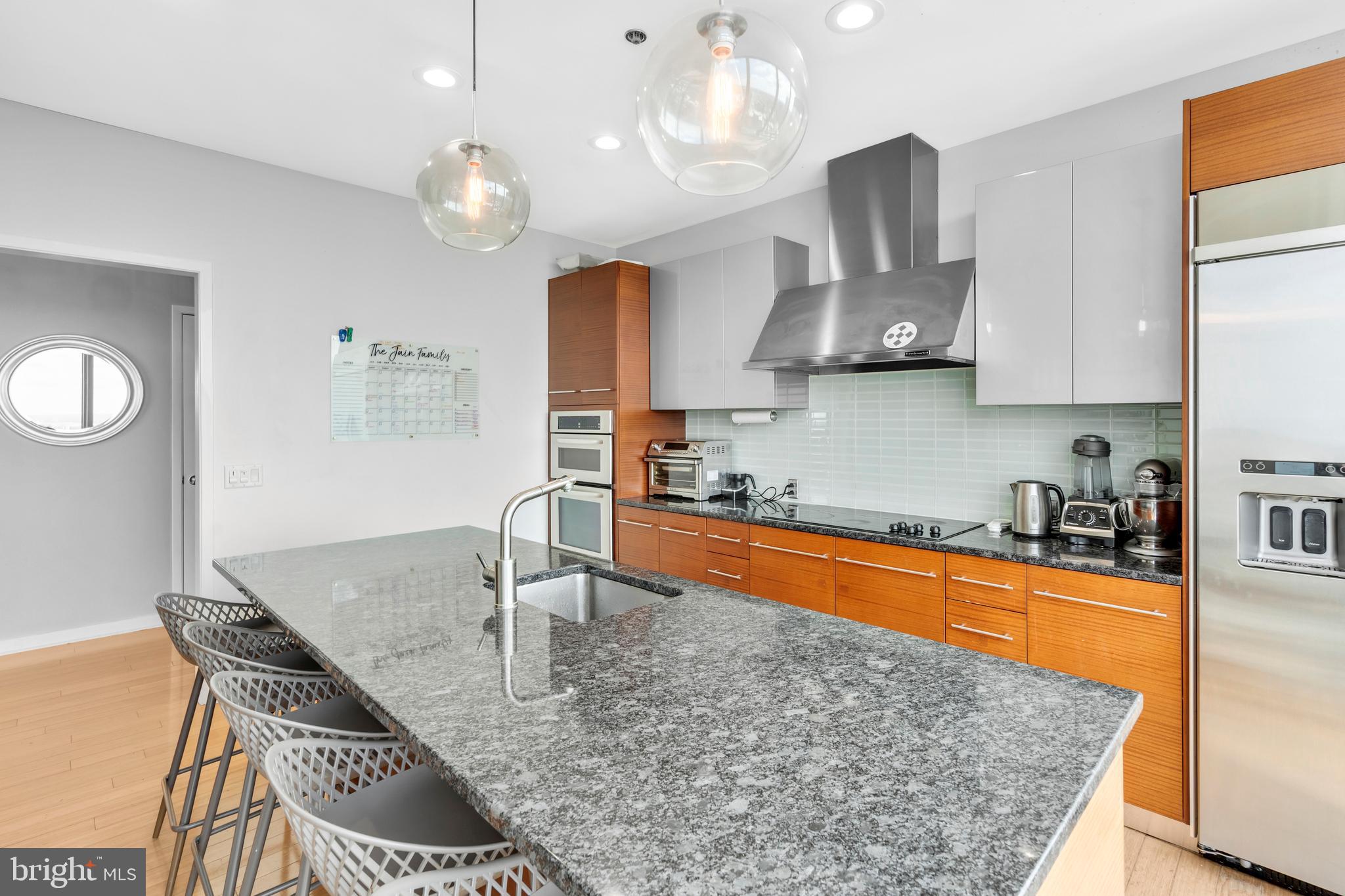 2101 Market Street, Unit PH02 Philadelphia, PA 19103 - Photo 8 of 56 a kitchen with stainless steel appliances granite countertop a sink a stove top oven a counter space and cabinets