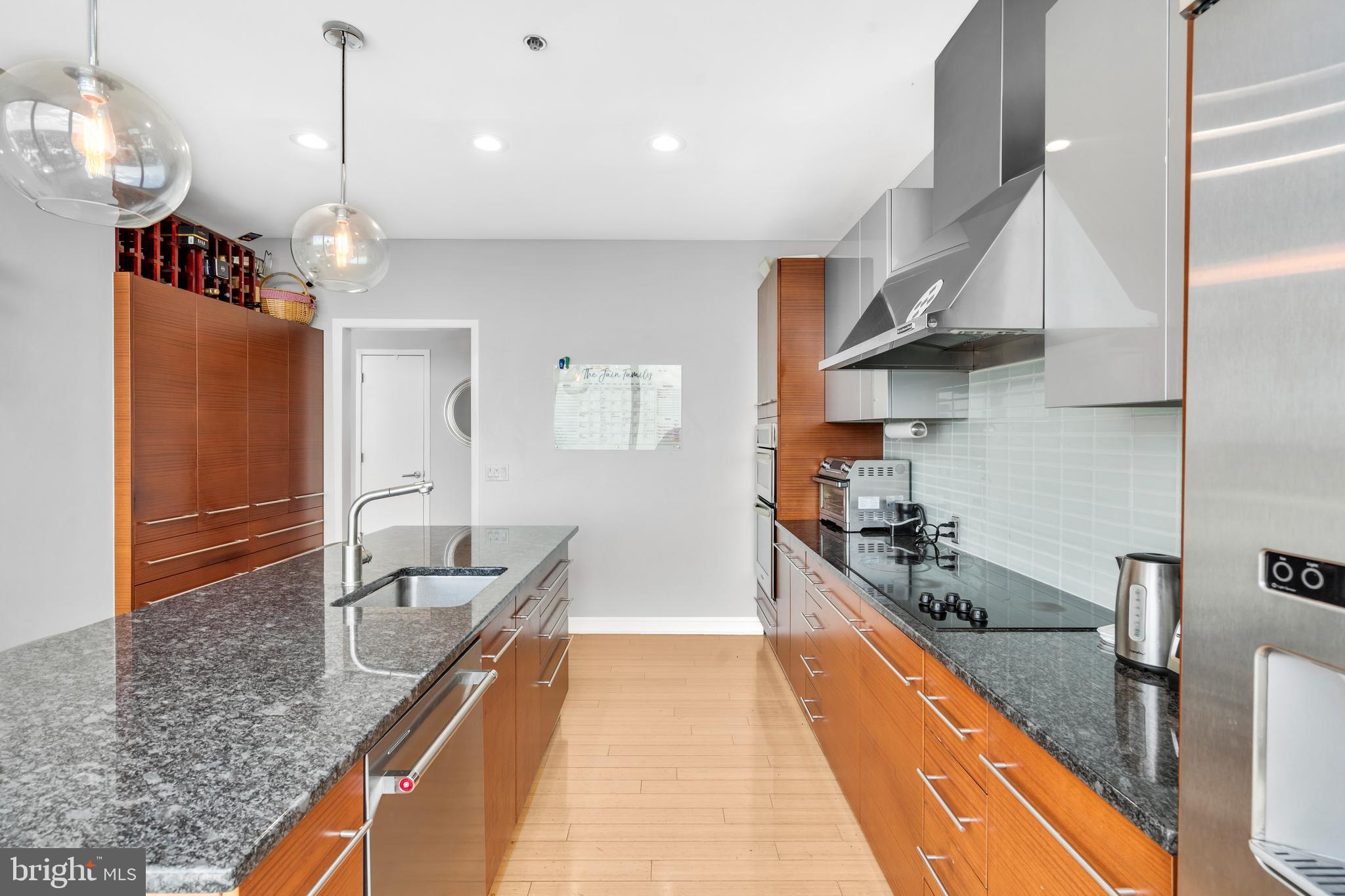 2101 Market Street, Unit PH02 Philadelphia, PA 19103 - Photo 9 of 56 a outdoor kitchen with stainless steel appliances granite countertop a sink a stove and a wooden floors