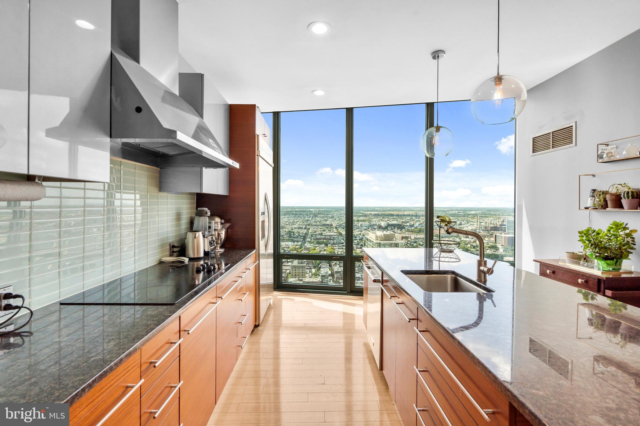 2101 Market Street, Unit PH02 Philadelphia, PA 19103 - Photo 10 of 56 a kitchen with sink a counter and cabinets