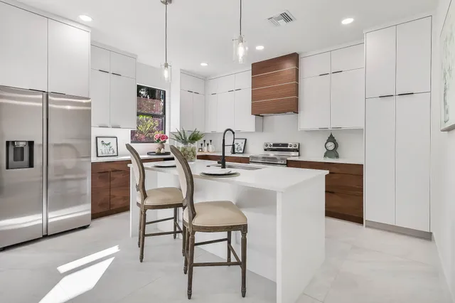 a kitchen with refrigerator cabinets and a sink