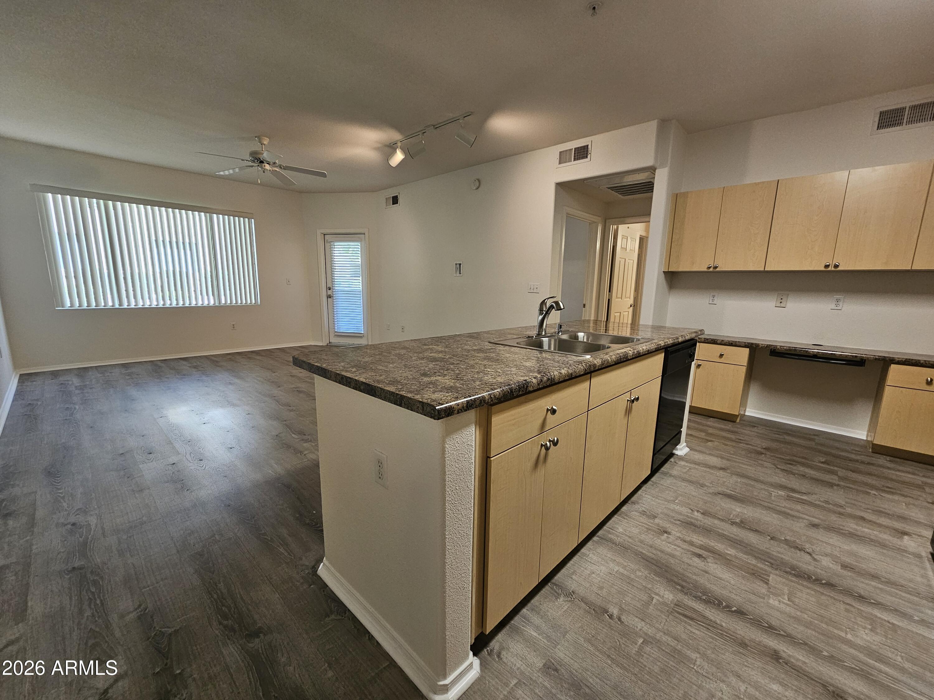 18416 North Cave Creek Road, Unit 1075 Phoenix, AZ 85032 - Photo 2 of 14 a kitchen with a sink stove and cabinets