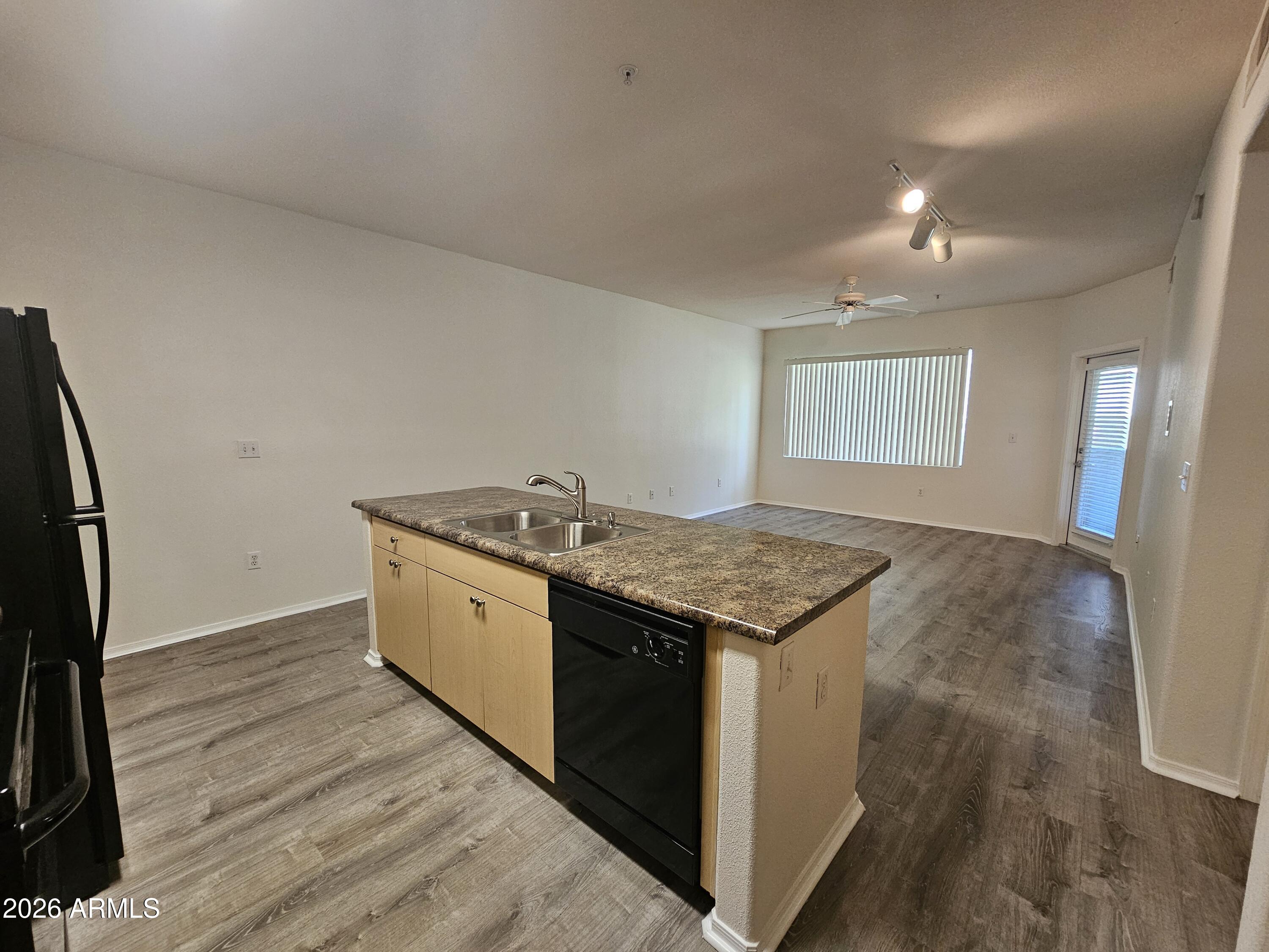18416 North Cave Creek Road, Unit 1075 Phoenix, AZ 85032 - Photo 3 of 14 a kitchen with granite countertop sink stove and refrigerator