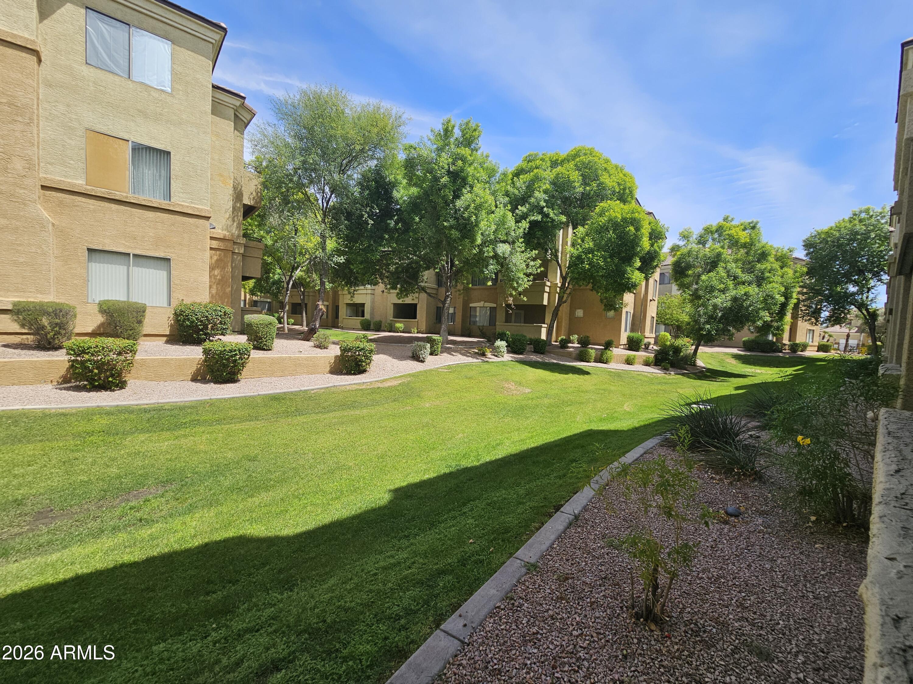 18416 North Cave Creek Road, Unit 1075 Phoenix, AZ 85032 - Photo 10 of 14 a view of a patio with table and chairs and potted plants