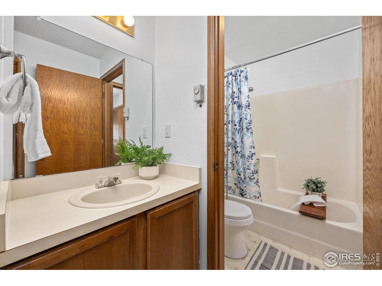 1231 West Swallow Road, Unit 314 Fort Collins, CO 80526 - Photo 13 of 29 a bathroom with a sink and a mirror