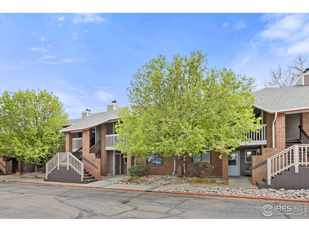 1231 West Swallow Road, Unit 314 Fort Collins, CO 80526 - Photo 2 of 29 a backyard of a house with table and chairs
