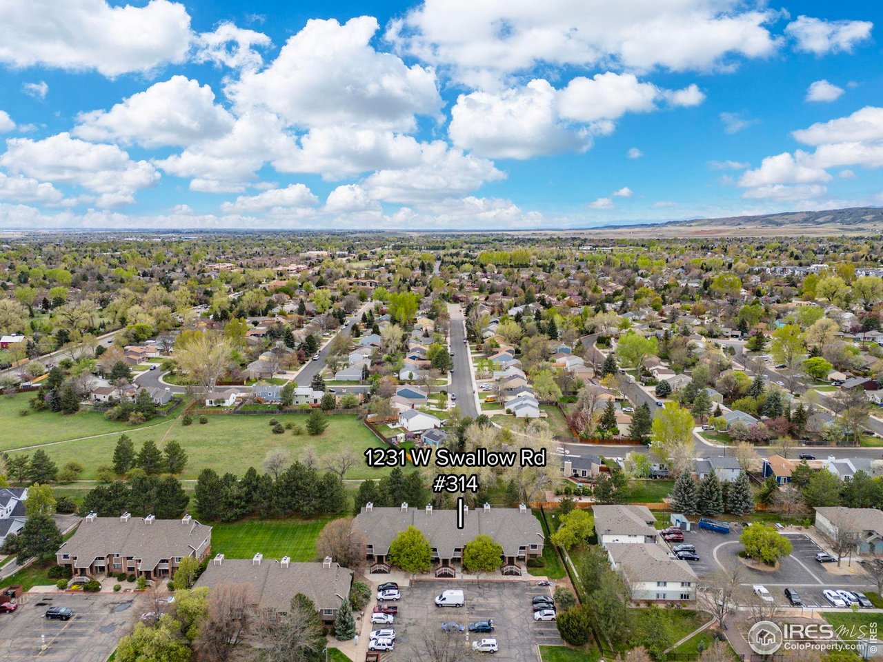 1231 West Swallow Road, Unit 314 Fort Collins, CO 80526 - Photo 25 of 29 an aerial view of a city with lots of residential buildings and mountain view in back