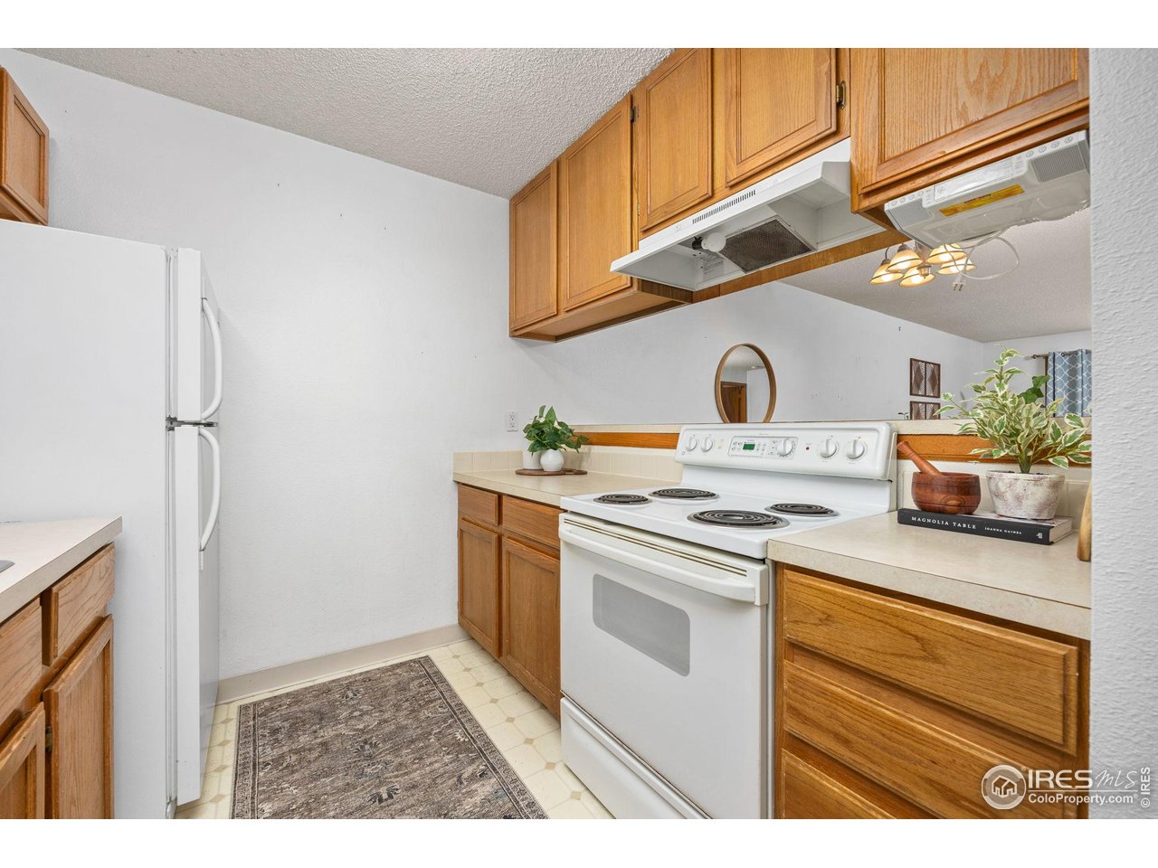 1231 West Swallow Road, Unit 314 Fort Collins, CO 80526 - Photo 6 of 29 a kitchen with stainless steel appliances granite countertop a sink a stove a refrigerator and cabinets