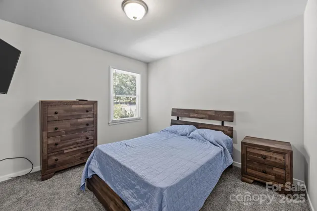 a bedroom with a bed and a television