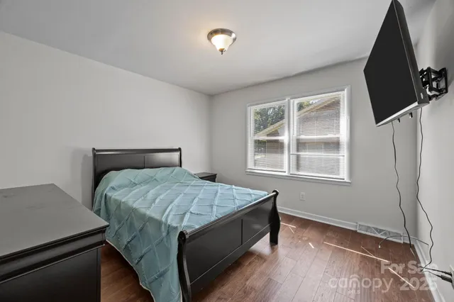 a bed sitting in a bedroom next to a window