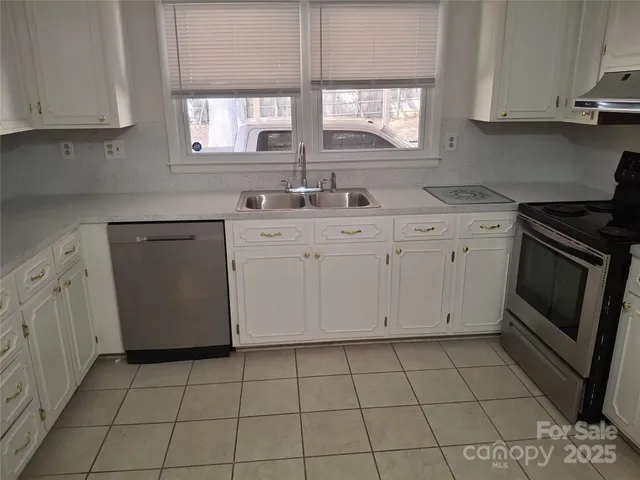 a kitchen with a sink stove and cabinets